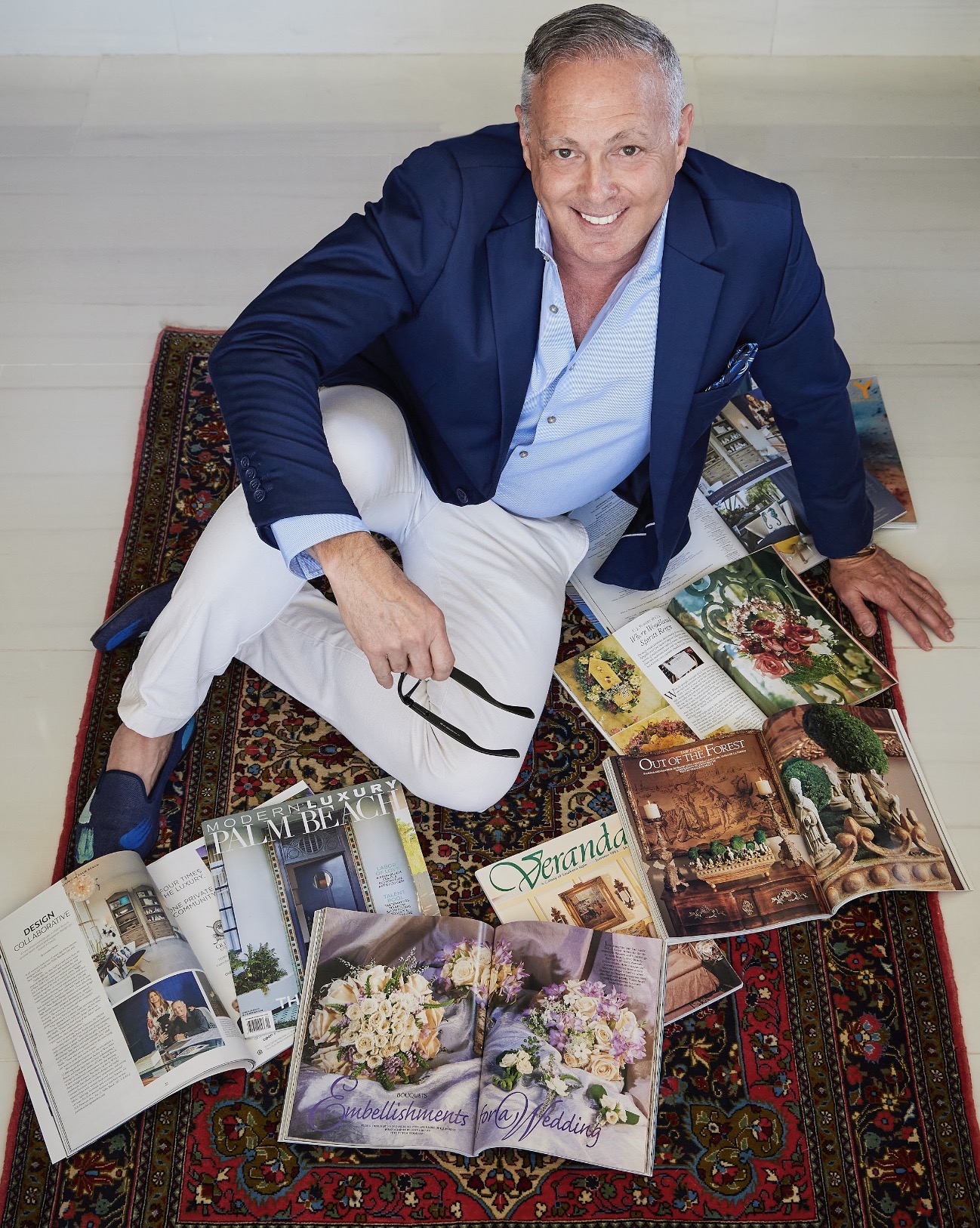 Carl showing press clipping higlighting the work of Palm Beach Design Masters.